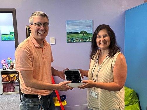 Visions Branch Manager of our Cortland office, Mark, kindly presents 170 pairs of blue Visions sunglasses to be used as giveaway for CAC's One Too Many 5K.