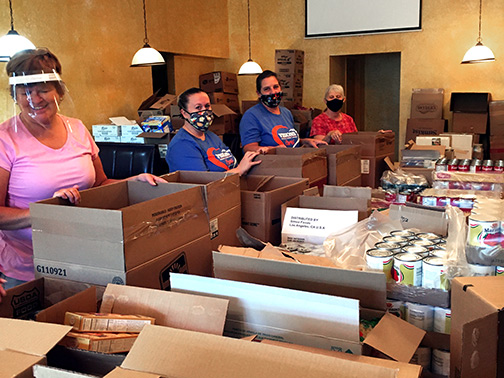 Visions employees packing food donations at the Spencer Van Etten Food Cupboard to be distributed to families in need.