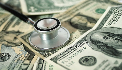 stethoscope on top of money