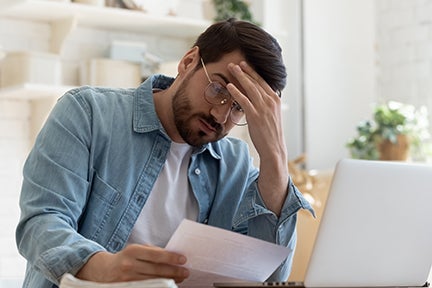 stressed man doing bills