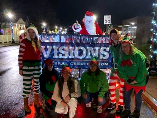 Visions employees dressed up as elves spreading holiday cheer during the parade.