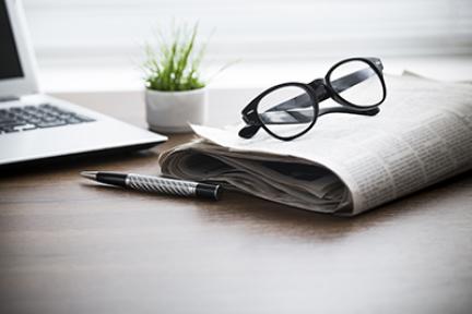 newspaper with glasses on it