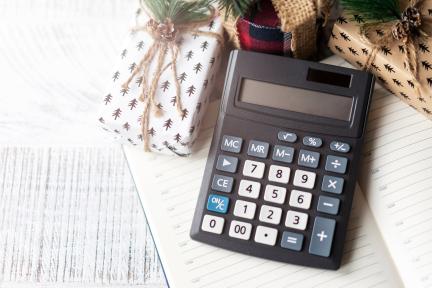 calculator and holiday gifts on a table