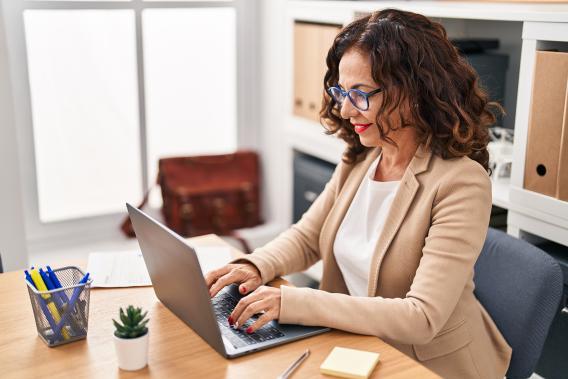 middle aged hispanic woman on laptop