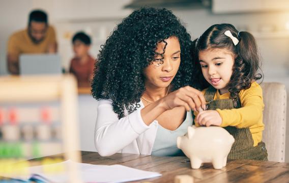 mother and daughter with piggy bank