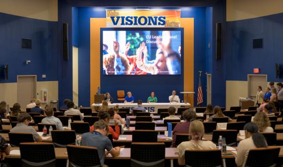 Audience of student interns at a panel discussion