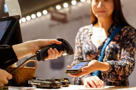 Cashier scanning a digital gift card