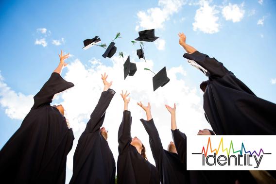 college students graduating and throwing caps into the air