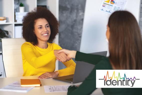 woman shaking hands with another woman over the table