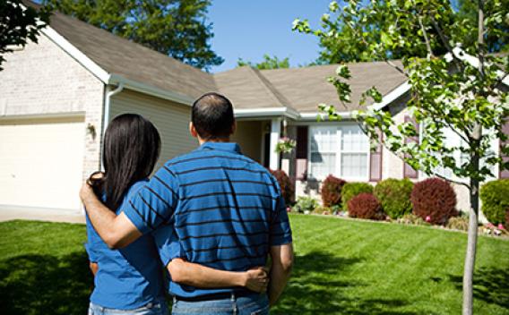 Home owners looking at their house.