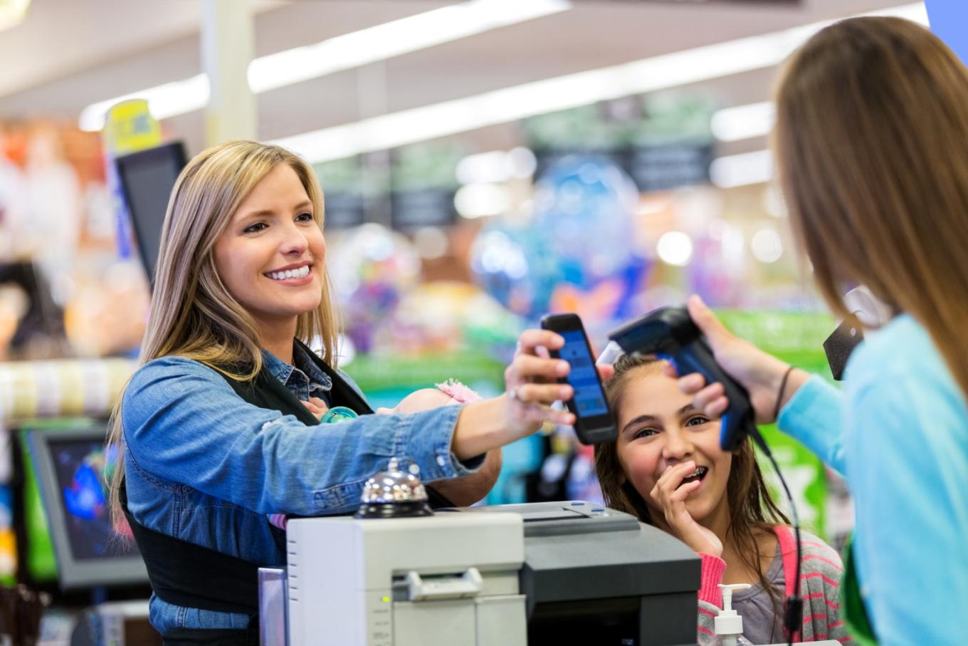 Family having their digital card scanned at store