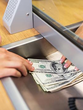 person giving deposit to teller